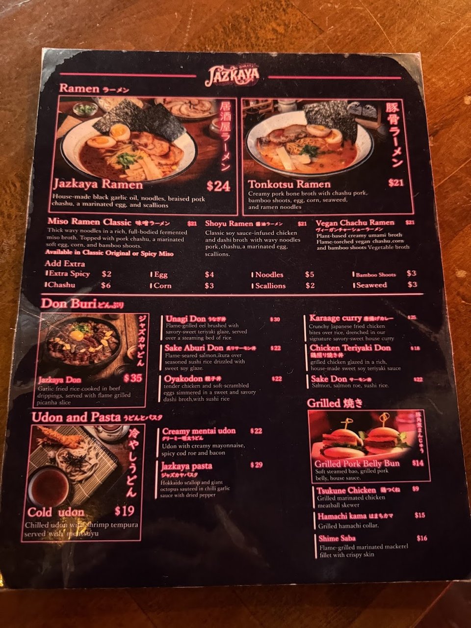 Menu board showing sushi, gyoza, and drinks.